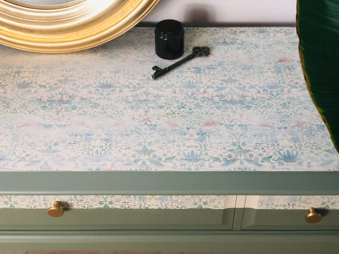 Stag Minstrel console table, painted in green with William Morris Strawberry theif paper detail and gold knobs