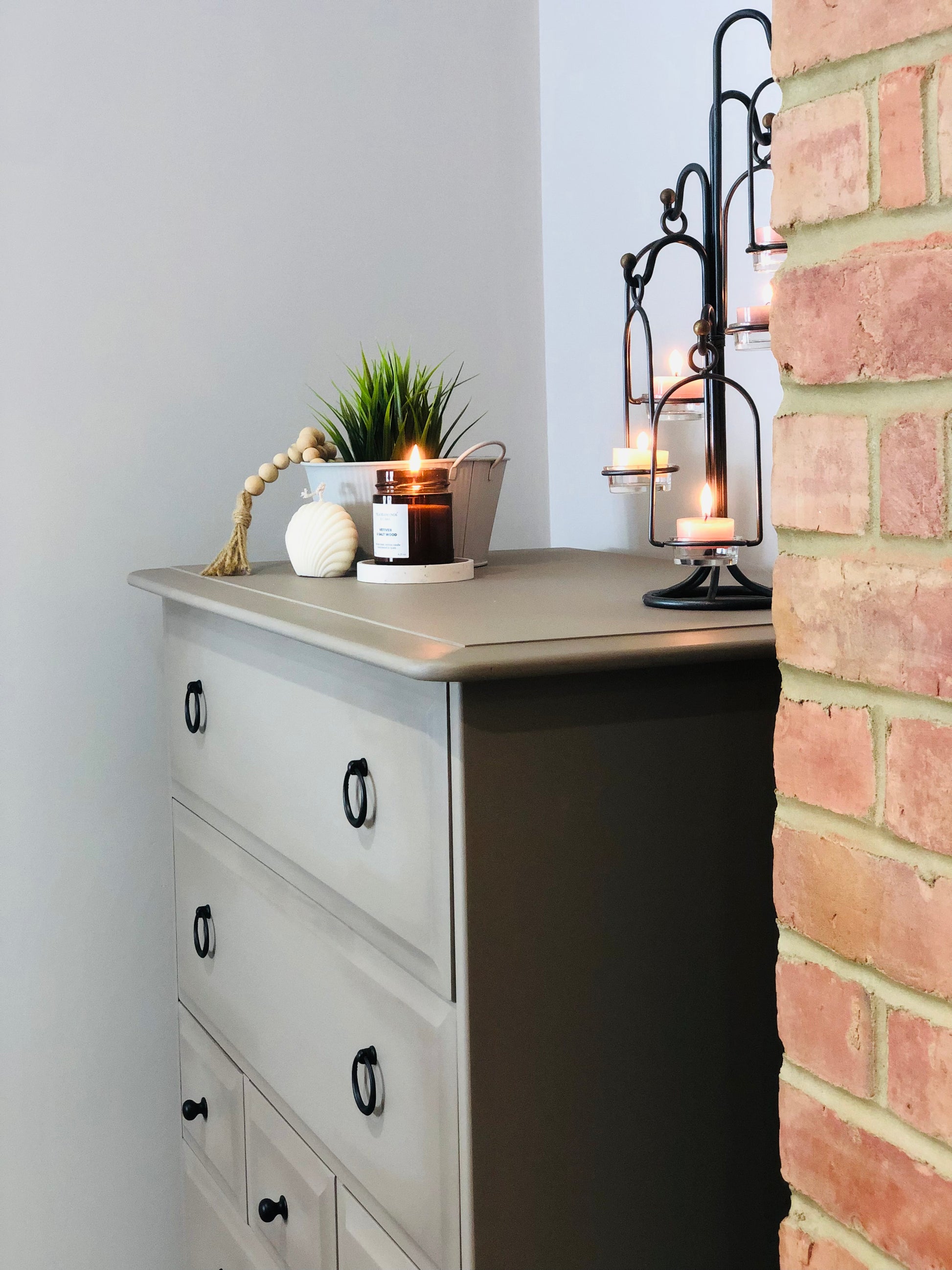 Stag Minstrel painted tallboy with 7 drawers, painted in a neutral shade, with matte black handles