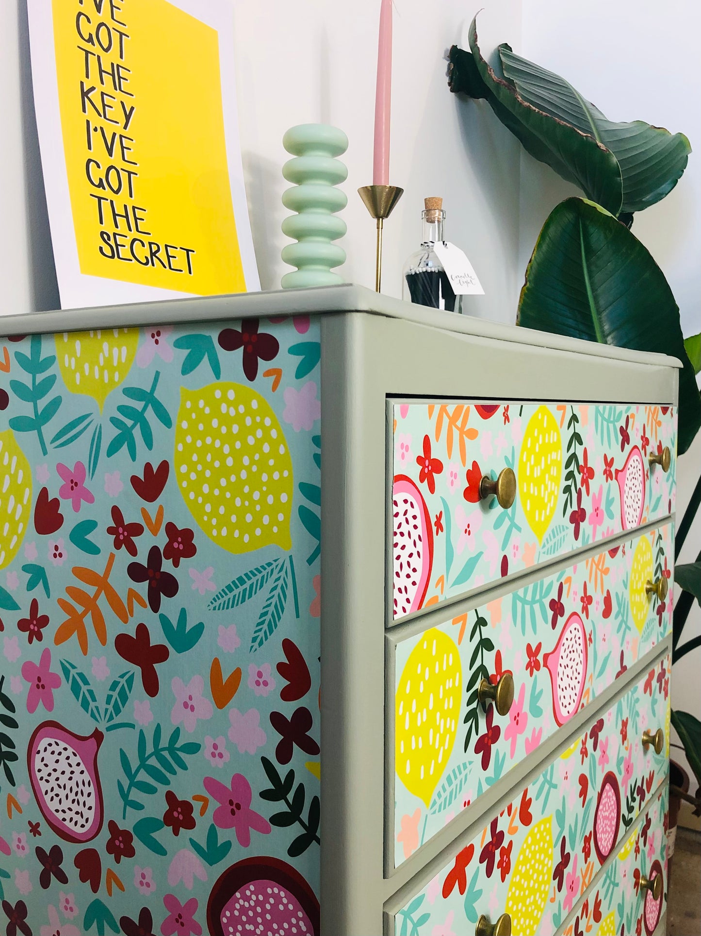 . Chest of Drawers, Painted Neutral Green, With Colourful Fruit And Floral Wallpaper Design